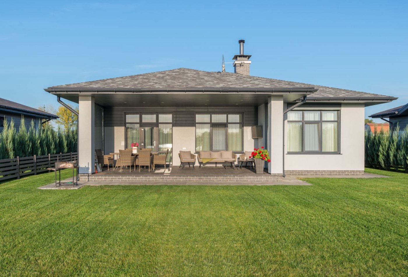A freshly mowed green lawn with planted borders in front of a Boise home